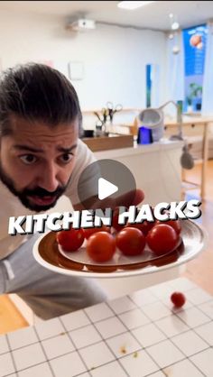 a man holding a plate with tomatoes on it and the caption kitchen hacks