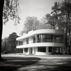 the circular house is surrounded by trees in black and white