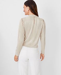 Elevate your style with the Ann Taylor Metallic Draped Cowl Neck Top, a shimmering addition to your wardrobe that combines elegance with comfort. This top features a luxurious metallic champagne color that complements any outfit, making it perfect for both day and night occasions.

- Size: 2XL
- Color: Metallic Champagne
- Material: 100% Polyester
- Gender: Female
- Fit: Relaxed
- Length: 22" long
- Features: Cowl neck, long sleeves with shirred sleeve caps, front shoulder pleats, front shirred Shirred Sleeve, Female Features, Ann Taylor Petite, Knitted Suit, Hip Style, Cowl Neck Top, Night Wear, Outfit Making, Petite Tops