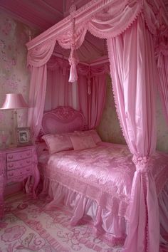 a pink canopy bed in a girls bedroom