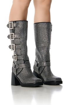 Biker meets chic. Introducing The AZALEA WANG Bronson Black Chunky Moto Boot. This chunky heel mid-calf boot features a glitter textile upper, a square toe silhouette, a slip-on fit, silver metallic hardware, and a chunky stacked heel. Complete with all-over rhinestone detailing, O-ring accents, harness-inspired embellishments, and pave buckle detailing down the sides. (all measurements are approximate from size 7.5) - Textile Upper - Textured Rubber Sole - Square Toe - 3.75” Heel Height - 12.5” Shaft Height - 12.75” Calf Circumference - Imported Product ID: 391641 Azalea Wang, Black Rhinestone, Mid Calf Boots, Moto Boots, Chunky Heel, Stacked Heel, O Ring, Chunky Heels, Mid Calf