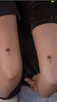 two people with small palm trees on their legs