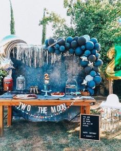 an outdoor party with balloons and decorations