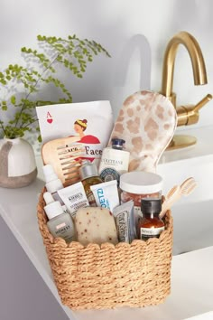 a basket filled with personal care items sitting on top of a counter next to a sink