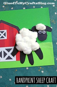 a handprint sheep craft made out of paper on a green background with snowflakes