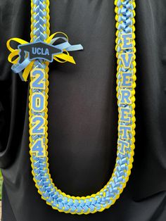 a blue and yellow lanyard with the university of north carolina on it's side