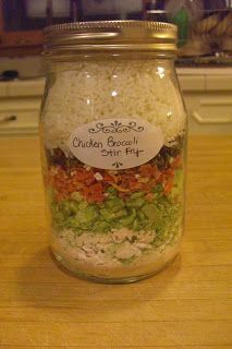 a glass jar filled with food sitting on top of a wooden table