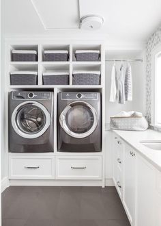 a washer and dryer in a white laundry room with lots of closet space