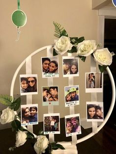 a white circular frame with photos and flowers on the side, attached to a wall