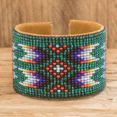 a colorful beaded bracelet on top of a wooden table