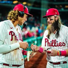 two baseball players are talking to each other