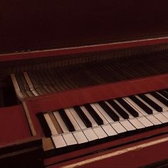 a red piano with white and black keys