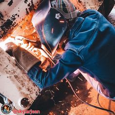 a man welding something in an industrial area