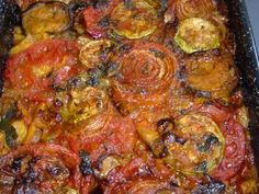 a casserole dish with tomatoes, onions and other toppings in a pan