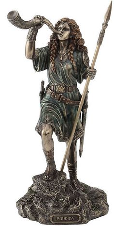 a statue of a woman holding a spear and wearing a green outfit with braids