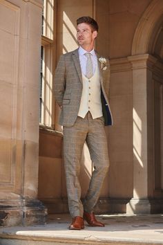 a man in a suit and tie standing on steps