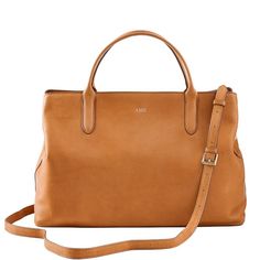 Super-functional and decidedly beautiful, the Caroline Leather Handbag is the ultimate work carryall. Spacious enough to fit a 13" laptop and everything else you need from 9 to 5, this versatile bag goes with everything, making it the perfect addition to your work wardrobe. Swap out the matching leather crossbody strap for one of our many colorful straps to create your own style.    17"w x 6"d x 11.25"h  Leather with a soft linen lining and gold-toned hardware.  See Product Information for more Classic Satchel With Detachable Strap For Everyday, Timeless Top Handle Satchel For Everyday, Classic Everyday Satchel With Detachable Strap, Timeless Everyday Top Handle Satchel, Timeless Satchel With Detachable Handle For Work, Timeless Workwear Satchel Shoulder Bag, Elegant Everyday Use Satchel Tote, Elegant Everyday Use Tote Satchel, Elegant Double Handle Satchel For Everyday