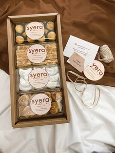 the box contains several different types of cookies and pastries, along with business cards