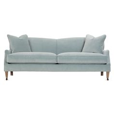 a light blue couch with two pillows on the back and one arm upholstered