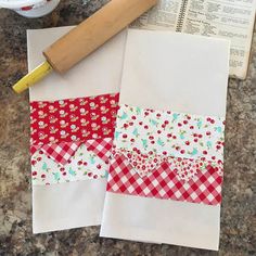 a piece of fabric next to a rolling pin on top of a table with paper