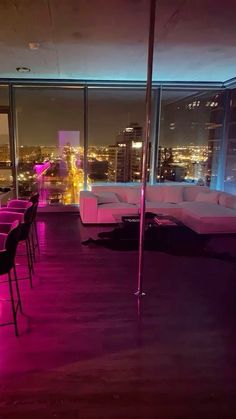 a living room filled with lots of furniture next to a window covered in purple light