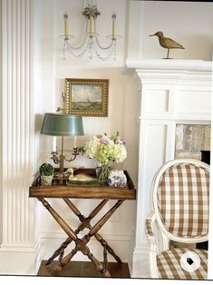 a living room with a chair, table and lamp in it's centerpiece