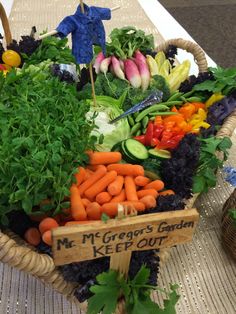 a basket filled with lots of different types of veggies on top of a table