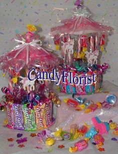 two candy boxes filled with candies and lollipops