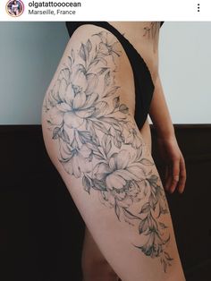 a woman's thigh with flowers and leaves on the side, as well as her lower leg