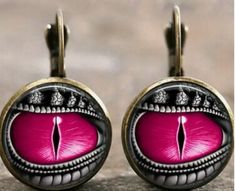 This Dragon Eye Earring set is truly piercing! The vivid Hot Pink and its vivid, vivacious hue captivate immediately. Take notice of this pretty antique looking set that is eye-catching! These come in many other fun colors too so add to your collection or be sure to at least take a further peek! Fashion jewelry is made of alloy type material Retro Adjustable Pink Earrings, Vintage Pink Metal Earrings, Artistic Pink Jewelry For Party, Artistic Pink Party Jewelry, Pink Cabochon Earrings As Gift, Pink Cabochon Earrings For Gift, Retro Pink Nickel-free Jewelry, Artistic Pink Nickel-free Earrings, Eye Piercing