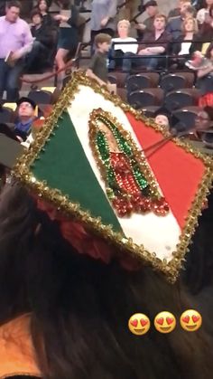 a woman wearing a decorated cap in front of an audience