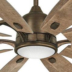 a ceiling fan with wooden blades and a light on it's side is shown