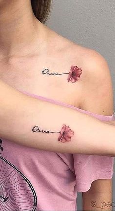 a woman's arm with two flowers on it and the word one written in cursive writing