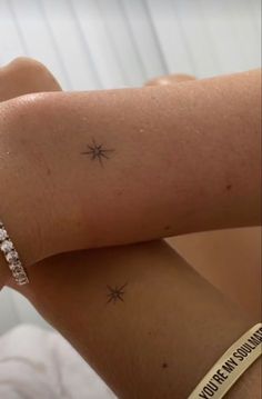 a woman's arm with a small star tattoo on the left side of her arm