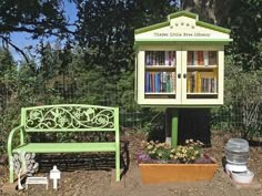 a green bench sitting next to a wooden book case and potted plant in front of it