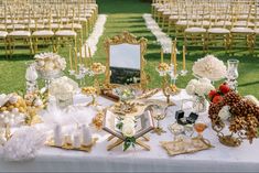 a table topped with lots of white and gold decorations