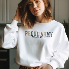 Show your unwavering support with our "Proud Army Mom" sweatshirt! This shirt proudly features the message in a combination of collegiate and script fonts, set against a color palette inspired by the Army, and boldly outlined in soft white. Product Details Ideal for any situation, a unisex heavy blend crewneck sweatshirt is pure comfort. These garments are made from polyester and cotton. This combination helps designs come out looking fresh and beautiful. The collar is ribbed knit, so it retains its shape even after washing. There are no itchy side seams on these sweaters. >50% cotton, 50% polyester >Medium-heavy fabric (8.0 oz/yd² (271.25 g/m²)) >Loose fit >Sewn-in label >Runs true to size Care Instructions Machine wash: cold (max 30C or 90F); Non-chlorine: bleach as needed; Tumble dry: l Cotton Team Spirit Sweatshirt With Lettering, Cotton Fan Apparel Sweatshirt With Text Print, Relaxed Fit Text Print Sweatshirt For School Spirit, Relaxed Fit Sweatshirt With Text Print For School Spirit, Relaxed Fit School Spirit Sweatshirt With Text Print, School Spirit Sweatshirt With Text Print In Relaxed Fit, School Spirit Cotton Sweatshirt With Lettering, Oversized Letter Print Sweatshirt For School, Oversized Letter Print Sweatshirt For School Spirit