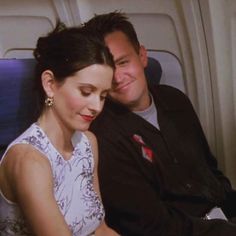 a man sitting next to a woman on an airplane