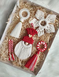 christmas ornaments in a box with straw and candy canes