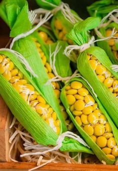 corn on the cob with yellow kernels in a wooden box, ready to be eaten