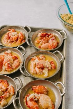 a tray filled with different types of food on top of a white counter next to a bowl