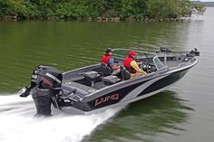 two men riding on the back of a black and gray boat