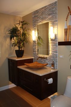 a bathroom with a toilet, sink and mirror in it's center piece is shown