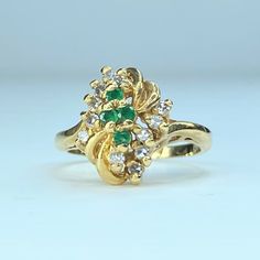 14k Yellow Gold Lady Statement Ring. It Cluster Setting Twelve (12) Round Brilliant Diamond And Four (4) Natural Emerald. Diamond Weight Approx. 0.2ct, Emerald Weight 0.12ct. Ring Top Is 14.2mm, Ring Size 6, Weight 4.7gm. Hallmark 14k Diamond Cocktail Ring, Diamond Cocktail Rings, Emerald Diamond, Natural Emerald, Brilliant Diamond, Cocktail Ring, Womens Jewelry Rings, Cocktail Rings, Statement Ring