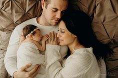 a man and woman are holding a baby