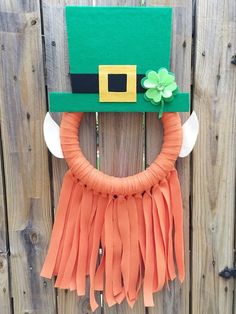 a st patrick's day wreath with a green hat on it