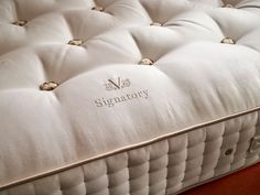 a close up view of a mattress with the name signatoory written on it