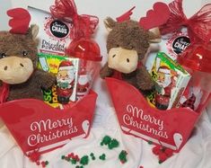 two stuffed animals are sitting next to each other with christmas candy in their mouths and on the table