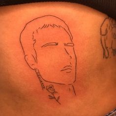 a drawing of a man's face on the side of his stomach is shown