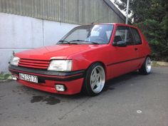 a red car parked in front of a building